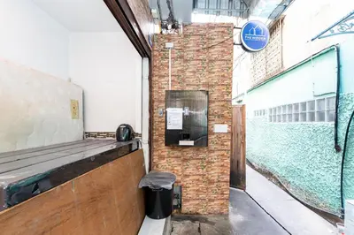 a brick wall with a phone on the side of a building at xx The Hidden Sao Chingcha - เดอะ ฮิดเด้น เสาชิงช้า in Bangkok