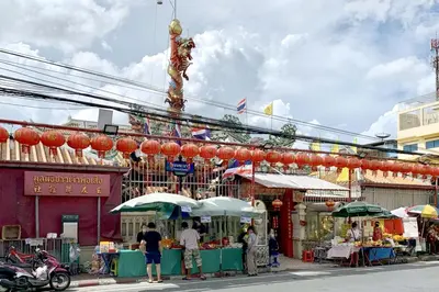 a group of people standing in front of a market at xx The Hidden Sao Chingcha - เดอะ ฮิดเด้น เสาชิงช้า in Bangkok