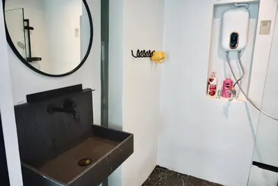 a bathroom with a sink and a mirror at Hash Apartment Silom Soi 3 triple room in Bang Rak