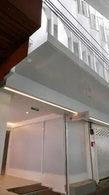 a building with white walls and a staircase at The Staytion Hotel at Sukhumvit in Amphoe Phra Khanong