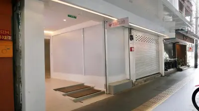 a corridor of a building with a door and stairs at The Staytion Hotel at Sukhumvit in Amphoe Phra Khanong
