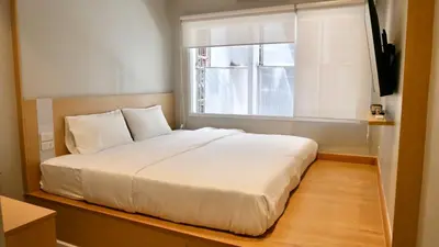a bedroom with a white bed and a window at The Staytion Hotel at Sukhumvit in Amphoe Phra Khanong