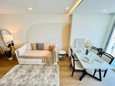 a living room with a couch and a table at Cozy Spacious 55sqm 1BR 200m BTS PhraKhanong, 10min Thonglo in Bangkok