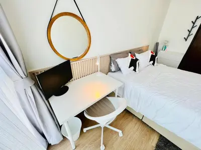 a small bedroom with a bed and a mirror at Cozy Spacious 55sqm 1BR 200m BTS PhraKhanong, 10min Thonglo in Bangkok