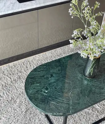 a glass table with a vase with flowers on it at Luxury room in Ban Khlong Bang Chak