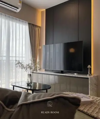 a living room with a large flat screen tv at Luxury room in Ban Khlong Bang Chak