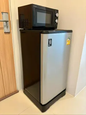 a microwave sitting on top of a refrigerator at 5 mins to Ari - Sutthisan in Bang Su