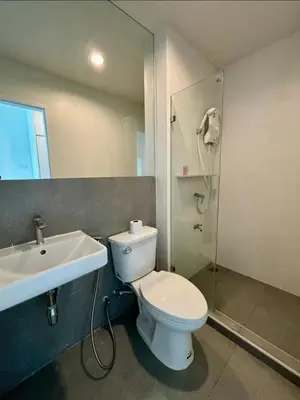 a bathroom with a toilet and a sink and a shower at 5 mins to Ari - Sutthisan in Bang Su