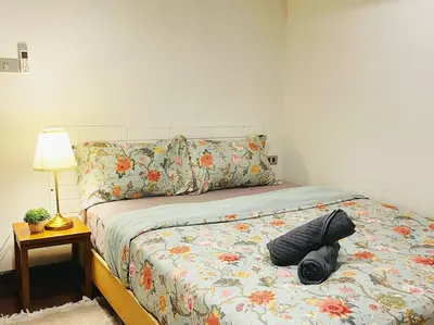 a bed with a comforter with a hat on it at 7 Beds Villa Emquartier BtsThonglor Phrom phong in Bangkok