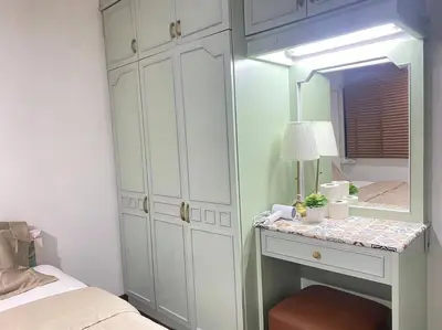 a bedroom with a mirror and a table with a lamp at 7 Beds Villa Emquartier BtsThonglor Phrom phong in Bangkok