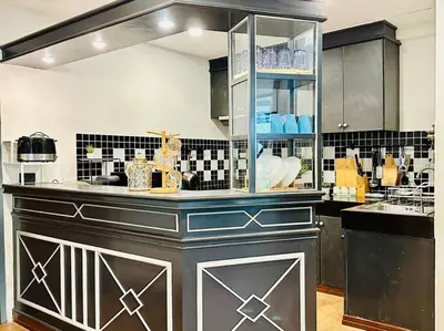 a kitchen with black and white tile on the wall at 7 Beds Villa Emquartier BtsThonglor Phrom phong in Bangkok