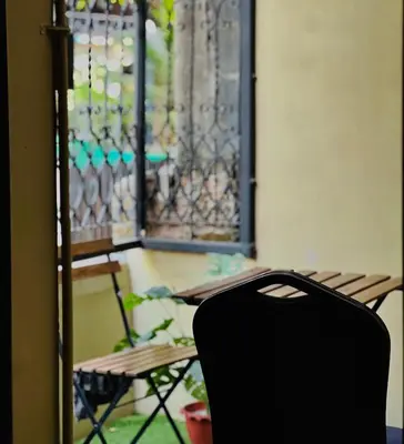 a chair sitting in front of a window at 7 Beds Villa Emquartier BtsThonglor Phrom phong in Bangkok