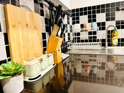 a kitchen with pots and pans on a counter at 7 Beds Villa Emquartier BtsThonglor Phrom phong in Bangkok