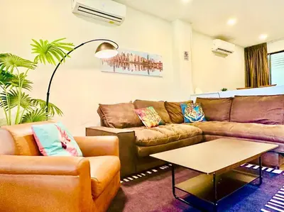 a living room with a couch and a table at 7 Beds Villa Emquartier BtsThonglor Phrom phong in Bangkok