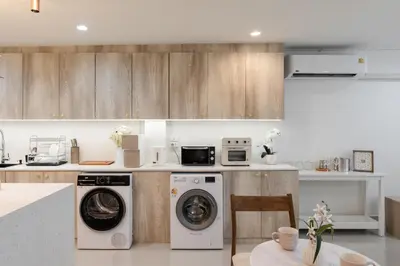 a kitchen with a washing machine and a dishwasher at Sweet stay in Bangkok