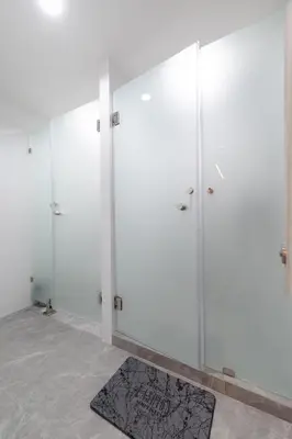 a room with white doors and a rug at Sweet stay in Bangkok