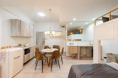 a kitchen and dining room with a table and chairs at Sweet stay in Bangkok
