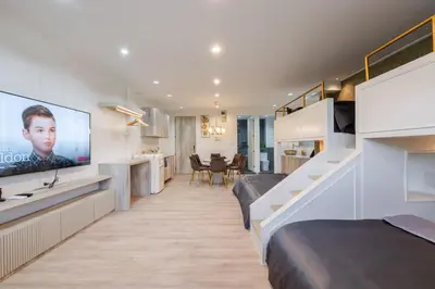 a room with two beds and a flat screen tv at Sweet stay in Bangkok