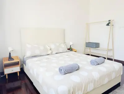 a bedroom with a large white bed with two pillows at 5BR House 8Beds, Ekkamai BTS 12mins walk, 711, shopping mall in Bangkok