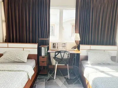 a bedroom with two beds and a desk and a window at 5BR House 8Beds, Ekkamai BTS 12mins walk, 711, shopping mall in Bangkok