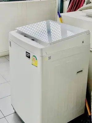 a small white refrigerator sitting in a room at 5BR House 8Beds, Ekkamai BTS 12mins walk, 711, shopping mall in Bangkok