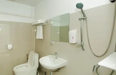 a bathroom with a toilet and a sink and a shower at The Hostel Era in Bangkok