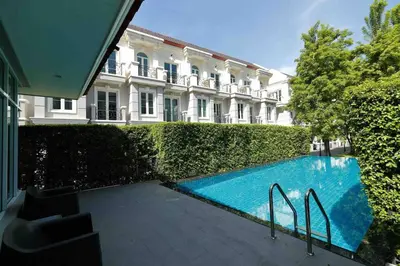 a swimming pool in front of a building at Sukhumvit 16 Townhouses, InHome Luxury Residences in Bangkok