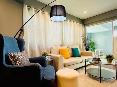 a living room with a couch and a table at 5BRHouse City centre Silom 3min to BTS Saint Louis in Bangkok