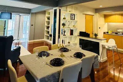 a dining room with a table and a kitchen at 5BRHouse City centre Silom 3min to BTS Saint Louis in Bangkok