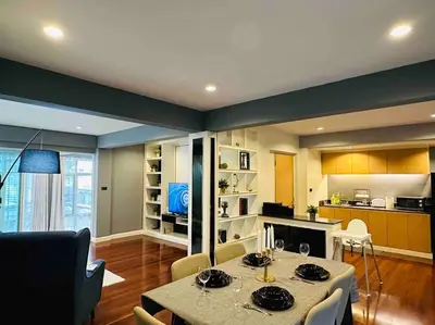 a living room with a table and a kitchen at 5BRHouse City centre Silom 3min to BTS Saint Louis in Bangkok