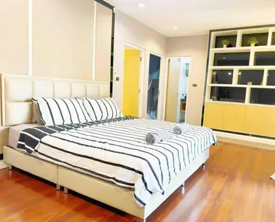 a bedroom with a large bed with striped pillows at 5BRHouse City centre Silom 3min to BTS Saint Louis in Bangkok