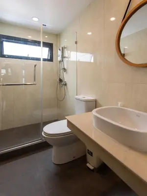 a bathroom with a sink and a toilet and a shower at Forfam at Ekkamai in Khlong Toei