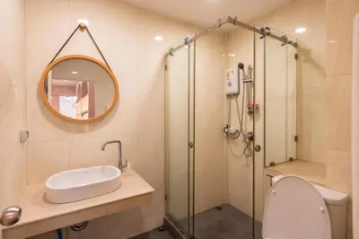 a bathroom with a shower and a toilet and a sink at Forfam at Ekkamai in Khlong Toei