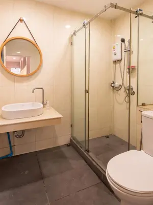 a bathroom with a shower and a toilet and a sink at Forfam at Ekkamai in Khlong Toei