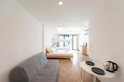 a living room with a couch and a table at Forfam at Ekkamai in Khlong Toei