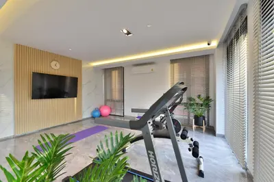a living room with a gym with a treadmill at V32 Hotel in Ban Zong Katiam