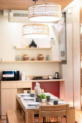 a kitchen with a wooden table with chairs and a tableablish at Pillow BKK Bliss townhome 5BR,7TL near BTS&MRT QSCC in Khlong Toei