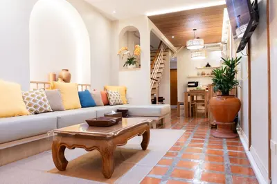 a living room with a couch and a table at Pillow BKK Bliss townhome 5BR,7TL near BTS&MRT QSCC in Khlong Toei