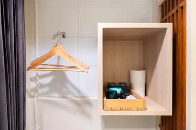 a wooden cabinet with a camera in a bathroom at Pillow BKK Bliss townhome 5BR,7TL near BTS&MRT QSCC in Khlong Toei