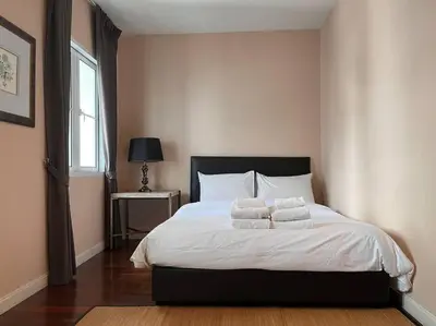 a bedroom with a bed with two pillows on it at 3BR Sukhumvit Townhouse, close to Emsphere and BTS MRT in Bangkok