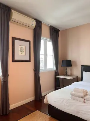 a bedroom with a bed and a window at 3BR Sukhumvit Townhouse, close to Emsphere and BTS MRT in Bangkok