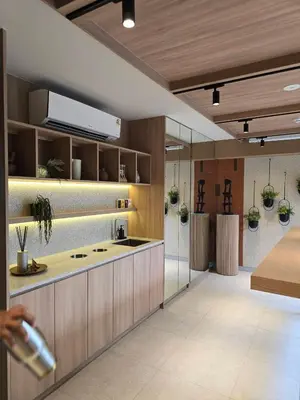 a kitchen with wooden cabinets and a counter top at The Chapter One Lifestyle Condo in Bang Khen