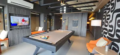 a room with a pool table and a tv at The Chapter One Lifestyle Condo in Bang Khen