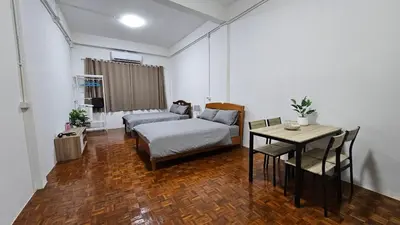 a living room with a bed and a table at NAN Square in Pratunam