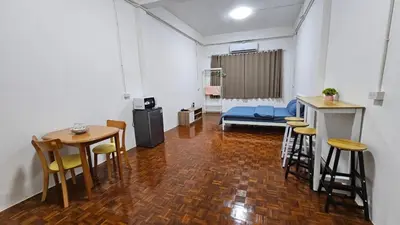 a room with a table and chairs and a couch at NAN Square in Pratunam