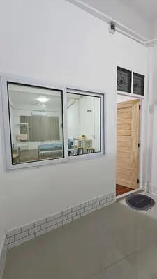 a white room with a mirror on the wall at NAN Square in Pratunam