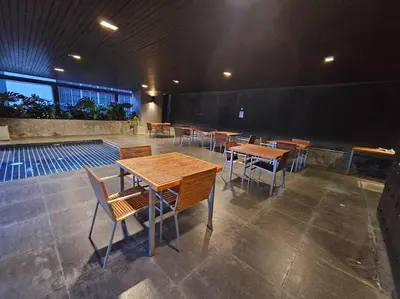 a group of tables and chairs in a building at 1BR at ThongLor BTS overlooking city with Workspace in Bangkok