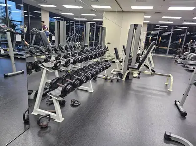 a gym with a row of treadmills and machines at 1BR at ThongLor BTS overlooking city with Workspace in Bangkok