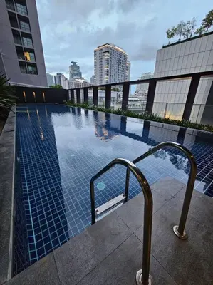 a swimming pool in the middle of a city at 1BR at ThongLor BTS overlooking city with Workspace in Bangkok