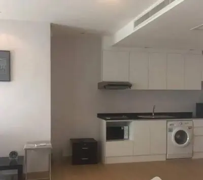 a white kitchen with a sink and a washing machine at Luxury Condominium in Bangkok